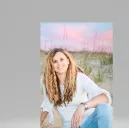 Susan is sitting on the beach at 47th street in Virginia Beach where she lived for 28 years.