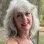 Dr. Ellen Mosti smiling in a colorful sleeveless top with shoulder-length silver hair.